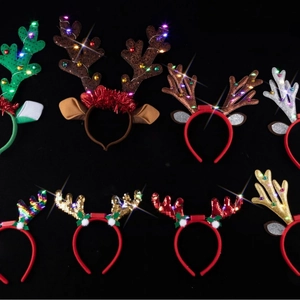LED glowing reindeer antler headbands with colorful sequins and plush holiday decorations