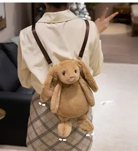 Back view of a cute plush lop-eared rabbit backpack with adjustable brown straps