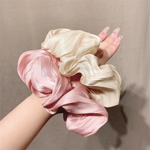 Glossy oversized satin hair scrunchies in pink and champagne with ruffled texture