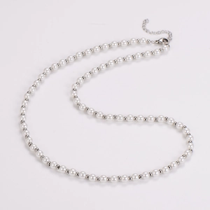 Detailed view of vintage pearl necklace with silver beads and adjustable metal clasp