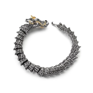 Vintage punk dragon bracelet in stainless steel with golden horns and green eyes