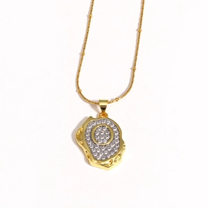 Close-up of 18k gold plated pendant necklace featuring letter O with zircon pavé