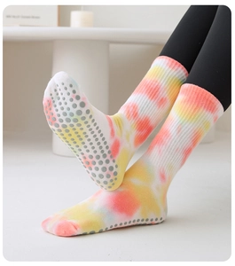 Detail of pink tie-dye pilates socks showing grey non-slip silicone grips on the sole