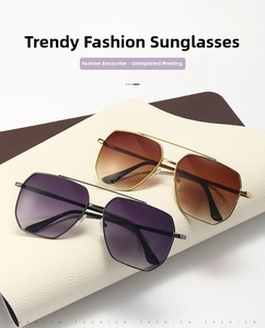 Detail view of double bridge sunglasses with metal frames and gradient lenses on leather