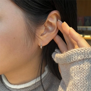 Close-up of minimalist S925 sterling silver geometric square hoop earrings on a model