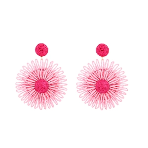 Macro detail of handmade pink raffia flower earrings with woven petal texture