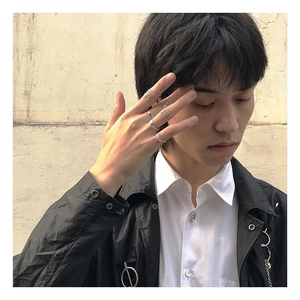 Detail of silver alloy ring set showing layered wearing effect on model's hand