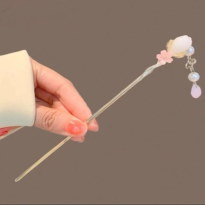 Detail of silver hair stick featuring pink peach blossoms and hanging pearl tassels