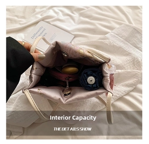 Spacious interior of a drawstring tote showing storage for wallet and umbrella