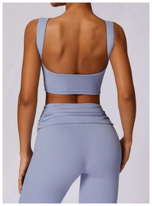 Detail view of ruched high waist yoga leggings and open back sports bra in light blue