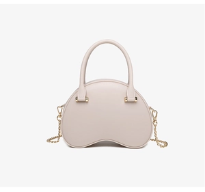 Detailed close-up of cream PVC jelly handbag featuring gold chain and hardware accents