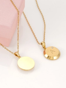 Detail of 18K gold plated stainless steel necklaces with round disk and 'A' pendant