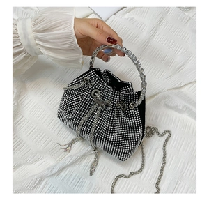 Close-up of black drawstring bucket bag with sparkling rhinestones and chain strap
