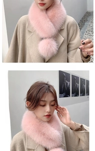 Detailed view of pink faux fox fur scarf with fluffy poms on a beige wool coat