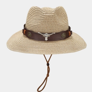 Detail of western straw hat with brown leather band and silver longhorn cattle emblem