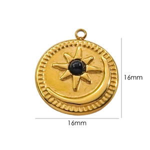 Detail of 16mm gold sun and moon astrology pendant with central black gemstone