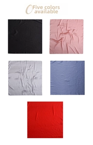 Flat lay detail showing five colors of satin square scarves in black, pink, grey and blue