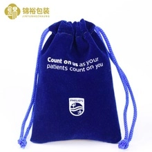Detail of dark blue velvet drawstring pouch with white logo for eyewear storage