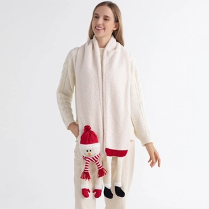 Detail of soft white plush scarf featuring a cute Christmas snowman plush ornament