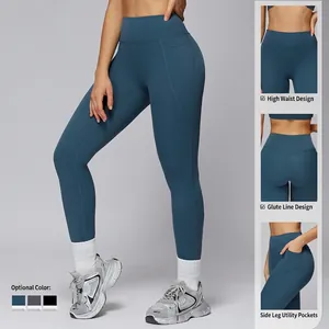 High-waisted yoga leggings with side pockets and bum-sculpting seams in dark teal color