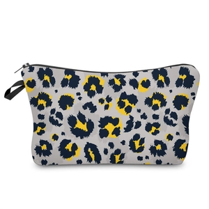 Detail of 3D leopard print makeup bag with smooth black zipper and textile handle loop