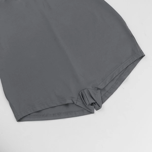 Detailed view of dark grey athletic playsuit showing precision stitching and fabric texture