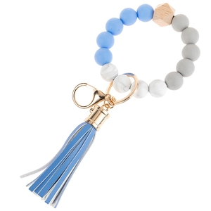 Detail of MAMA silicone bead keychain bracelet with blue tassel and gold metal ring