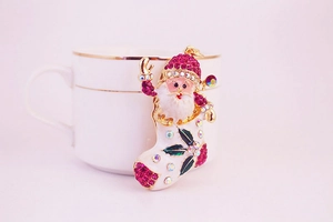 Detailed view of Santa Claus Christmas stocking brooch with sparkling colorful rhinestones