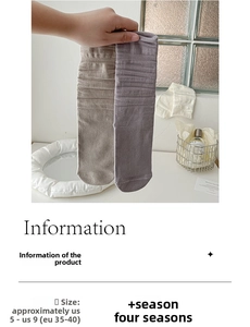 Detail view of cotton texture on khaki and grey slouch socks with sizing chart info