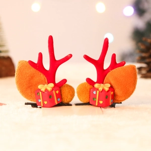Detail of Christmas reindeer antler hair clips with plush leaves and gift box ornaments