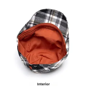 Detail view of the vintage plaid beret hat with orange fabric lining and metal button