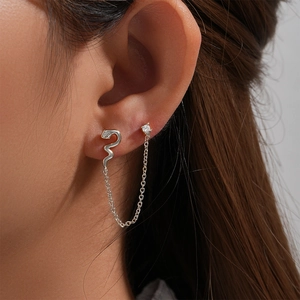 Detail of s925 silver snake earring chain with cubic zirconia stud on ear