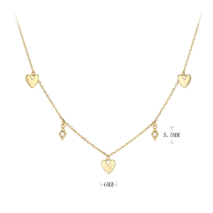 Detailed view of gold necklace with 6mm heart and 5.5mm diamond-shaped pendants