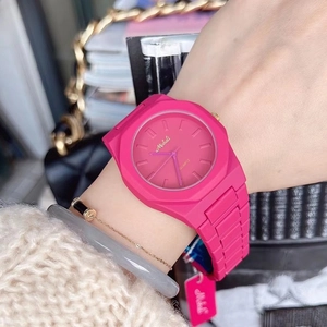 Close-up of pink silicone watch for women featuring minimalist quartz dial on wrist