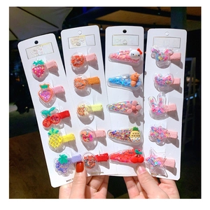Close-up of glitter hair clips set with colorful sequins for children on card