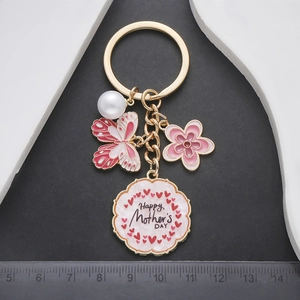 Golden keychain with pink enamel butterfly, flower, pearl and Mother's Day charm