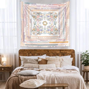 Detail of bohemian mandala tapestry with floral patterns hanging in a cozy bedroom