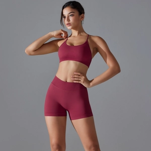 Detail of wine red ribbed knit yoga set featuring U-neck sports bra and high-waist shorts