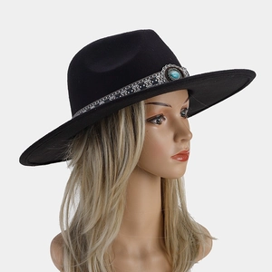 Detail of black felt fedora featuring bohemian band and turquoise stone ornament