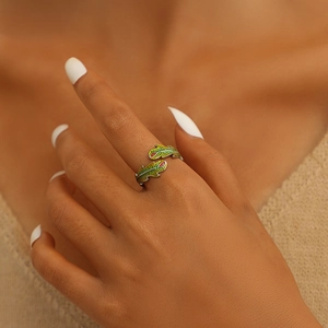 Detail of adjustable bionic leaf ring with green enamel finish and red dots on hand