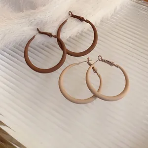 Exaggerated matte finish hoop earrings in brown and beige colors with silver needles