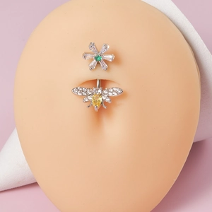 Detail of silver belly ring with sparkling flower and yellow gemstone bee on model
