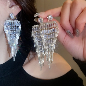 Close-up of sparkling full zircon flower tassel earrings with luxury silver finish