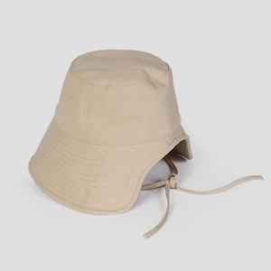 Detail of premium canvas fabric and windproof drawstring on beige sun hat