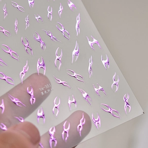 Detail of purple metallic flame nail stickers on transparent film with fine texture