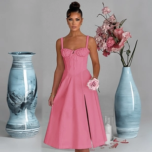 Close-up of pink slip dress featuring a corset style bodice and elegant side slit detail