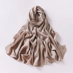 Close-up of elegant beige silk shawl showing soft texture and premium material luster