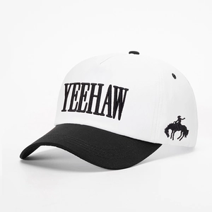 Detailed close-up of high-quality YEEHAW embroidery on black and white cotton baseball cap