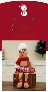 Detail of Christmas gingerbread man plush toy sitting on a wood log with festive attire