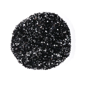 Top view of black velvet beret with shiny sequins over the round fabric surface